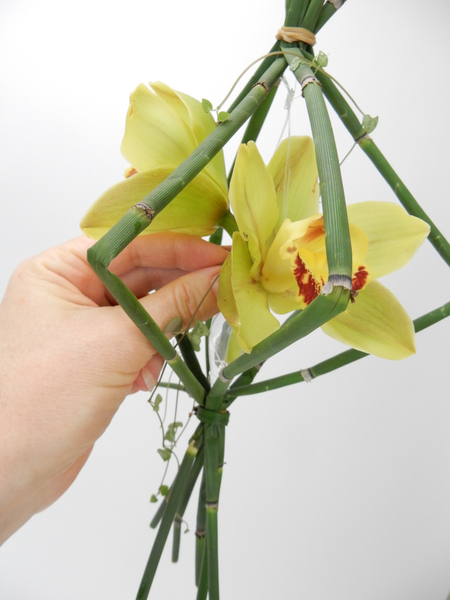 Place the flowers and the vine in the vase