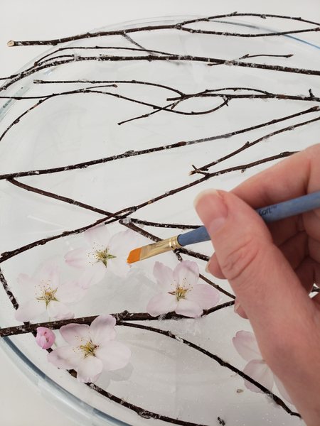 Build up a still life by adding blossoms between the twigs