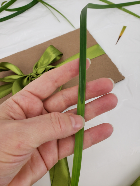 Connect strands of grass so that they wrap around the cardboard easily