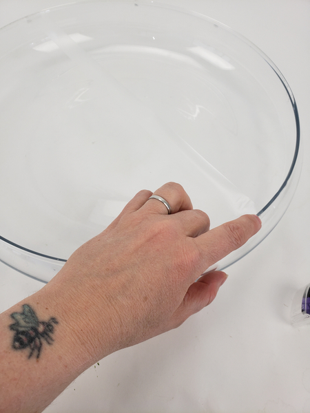 Stick down a grid of clear sticky tape over a shallow container