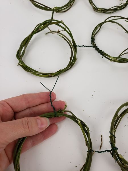 The next step is to connect the pairs of wreaths