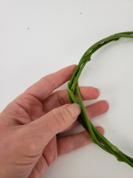 This way the end is concealed and the wreath will stay intact as you wiggle stems through it