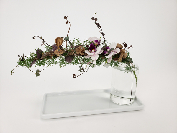 Design a floral arrangement in a small bud vase