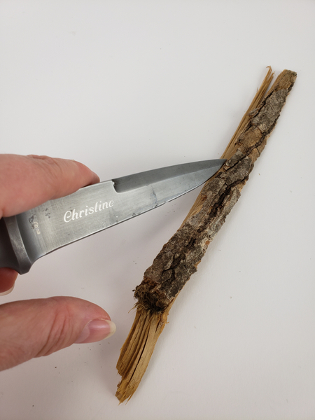 Strip bark from wood with a sharp knife