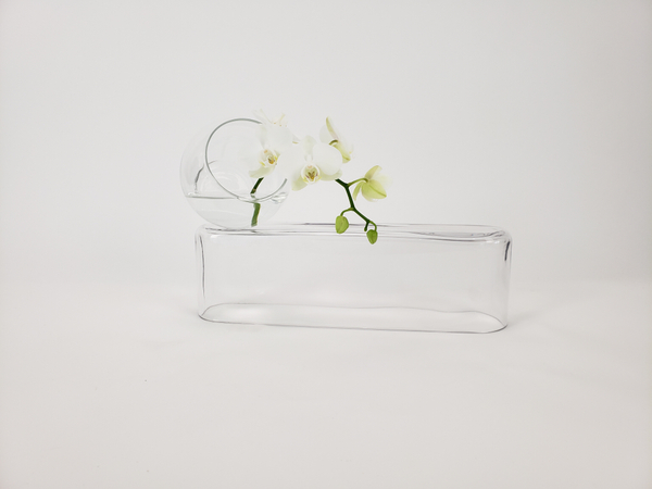 A clear glass and water summer flower arrangement