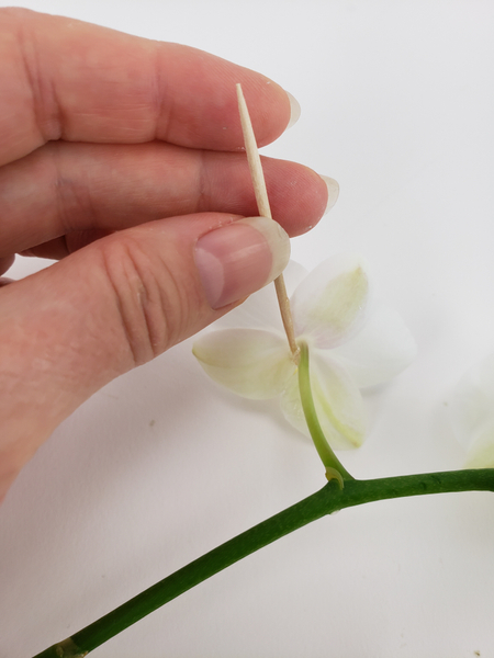 Apply the tiniest bit of glue to the flower