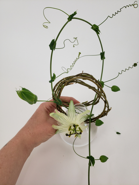 Carefully curve the vine and slip it through both the wreaths