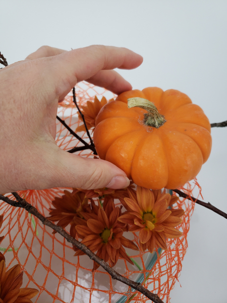 Place the pumpkins to rest on the twigs