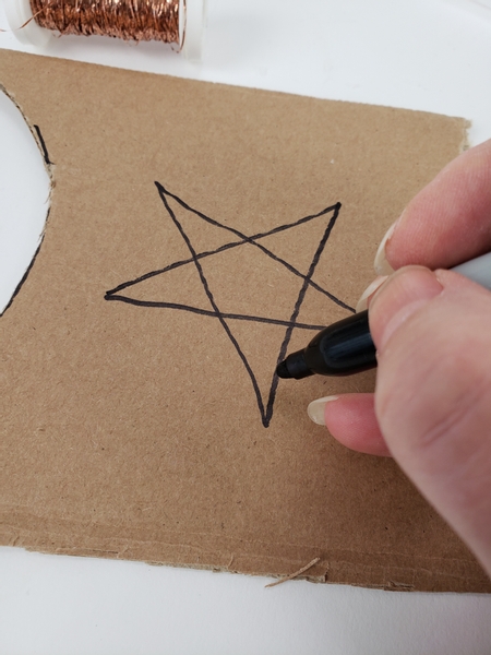 Draw a star shape on cardboard