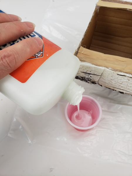 Pour wood glue out into a small container