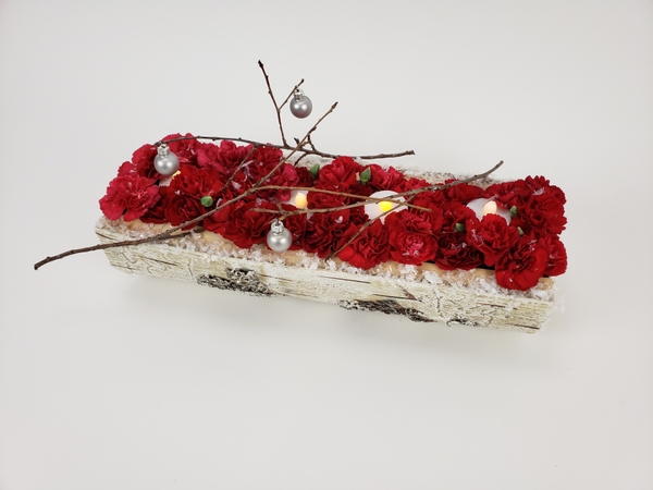 Red carnations for a rustic Christmas display