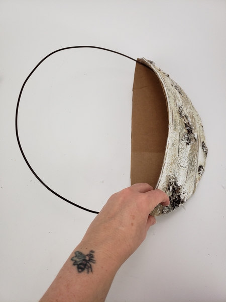 Slip the wire into the cardboard shape