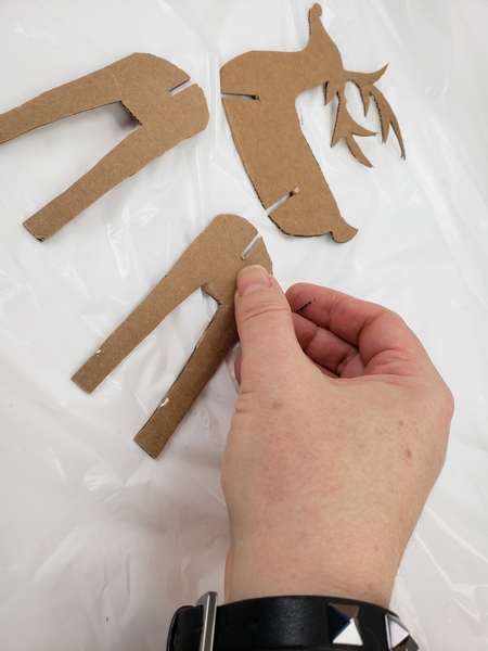 Draw a basic reindeer outline on cardboard and cut it out.