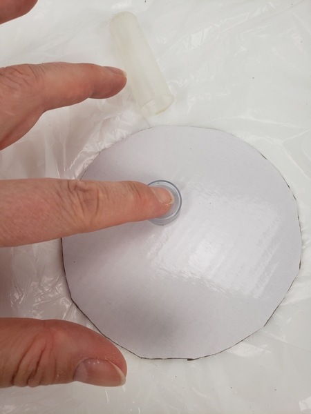 Trace the outline of a rubber seal of a water tube on to the cardboard