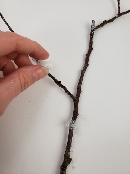 Add a few bits of artificial snow to a fresh winter twig Add a few bits of artificial snow to a fresh winter twig