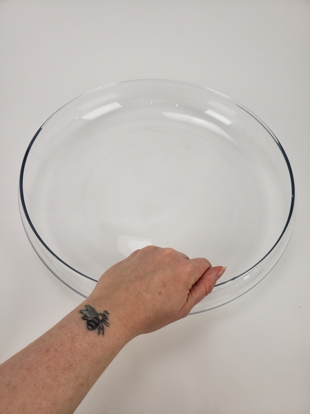 Place a large glass container on a flat surface