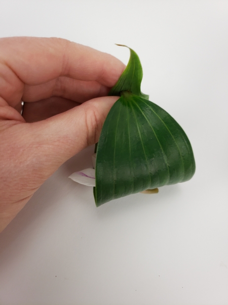 Roll the leaf over and slip the stem end through the hole