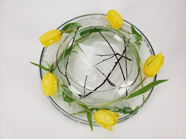 Using two glass vases to make a clear flower arrangement