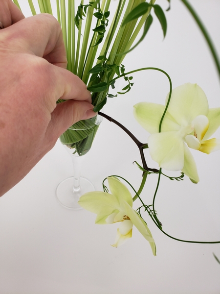 Add in the orchids to cascade out of the armature