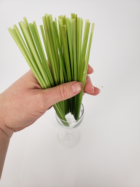 Cut away the reed ends and slip the grass into a glass