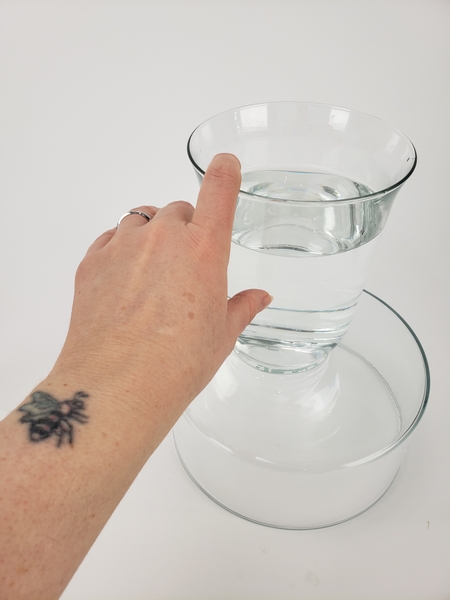 Place a water filled vase on a display surface