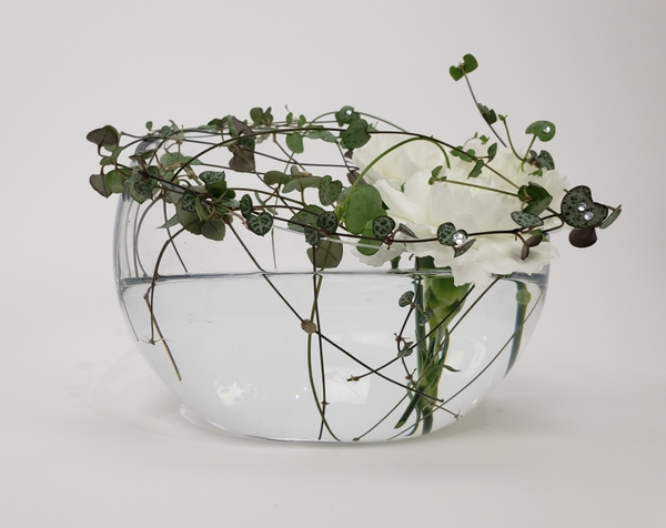 Suspend flowers over a container by weaving a natural grid