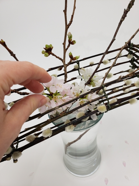 Place a few blossoming stems into the basket