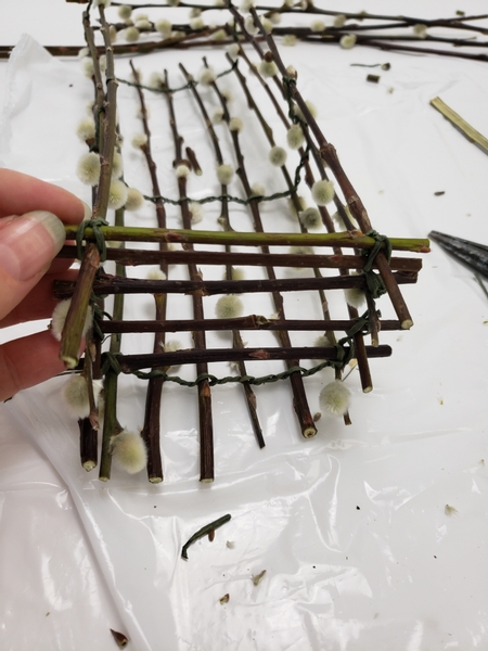 Wire in a ladder of twigs to close up the sides of the basket