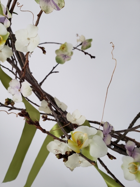 Adding dried flowers to a fresh Spring wreath