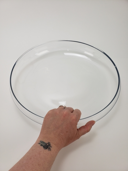 Place a shallow round container on your working surface