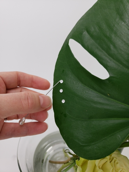 Add a few dew drop crystals to the monstera to finish the design