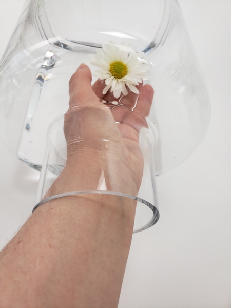 Gently float the flower inside the container