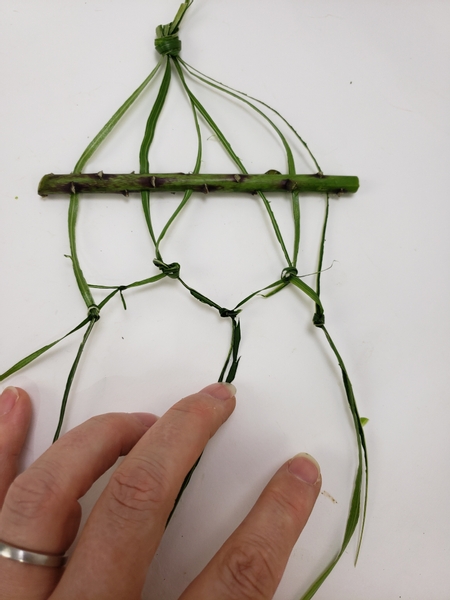 Split the middle knot and knot the leftover strands