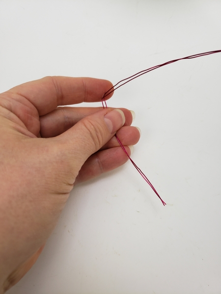 Start shaping the wire by bending it at an angle