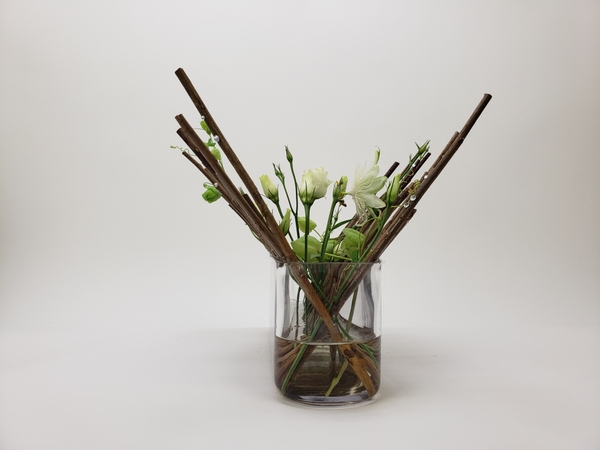 Neatly stacked dried twigs in a modern minimal flower arrangement