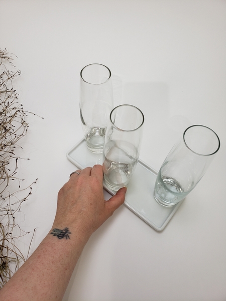 Place bud vases on a display tray