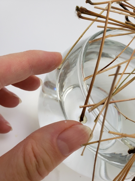 Add in two more stems but this time use hot glue to secure the stems to the grid and the vase.