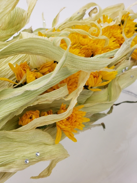 Corn husk and chrysanthemum flower arrangement for autumn decorating