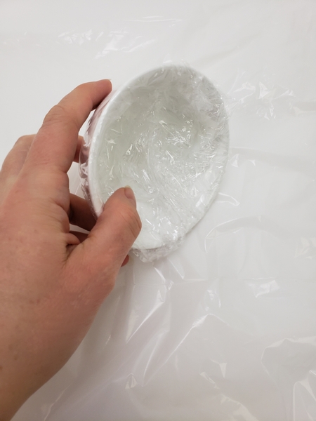 Cover a small bowl with plastic wrap