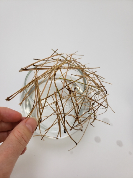 Let the stem snipped grid slip down one side of the vase Let the stem snipped grid slip down one side of the vase