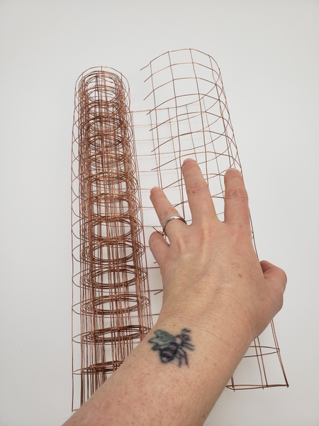 Measure out the wire mesh to the size of the corn armature you require