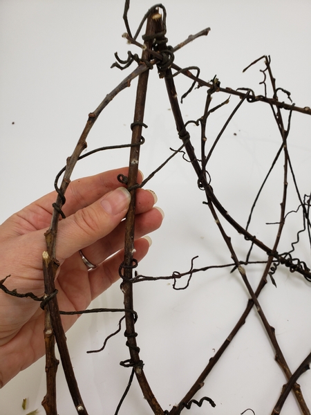 Add in a few more wire vines between the twigs to make the gapes even smaller