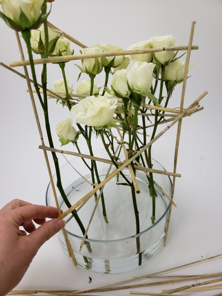 Anchor the roses with wheat stems