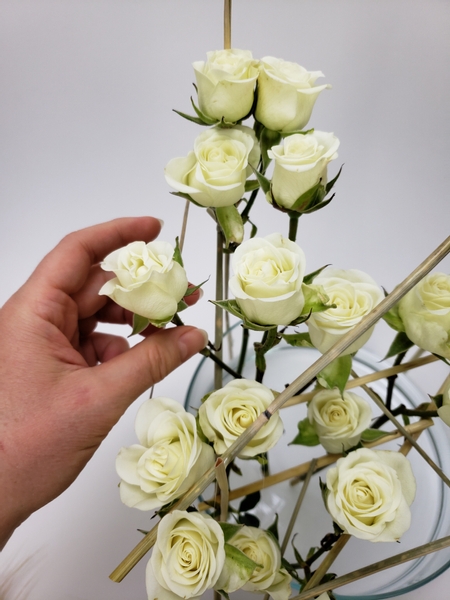 Fill the space with spray roses and neatly keep them upright with stems