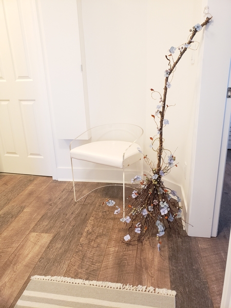 Minimal Halloween styling a broom in an entry way