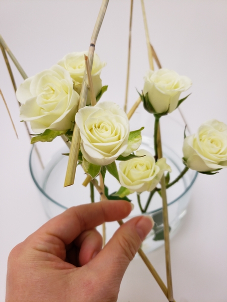 Place the next stem of spray roses