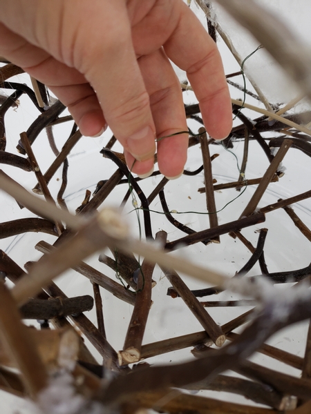 And spread out the lights inside the twig snowman.