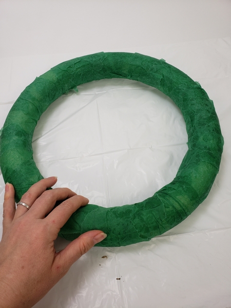 Cover a foam wreath frame with tissue paper