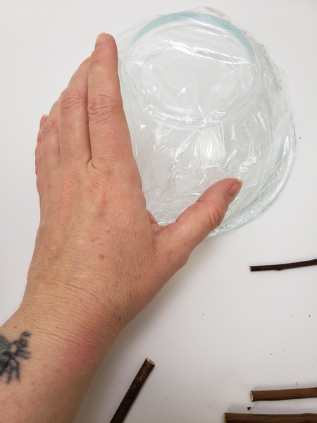 Cover a glass container with wrap