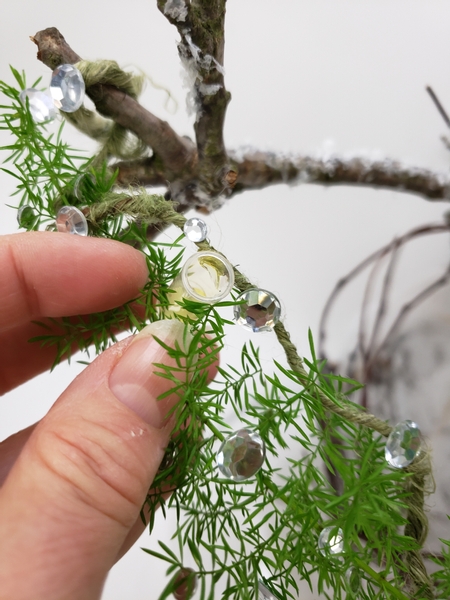 Glue in tiny water tubes into the garland.
